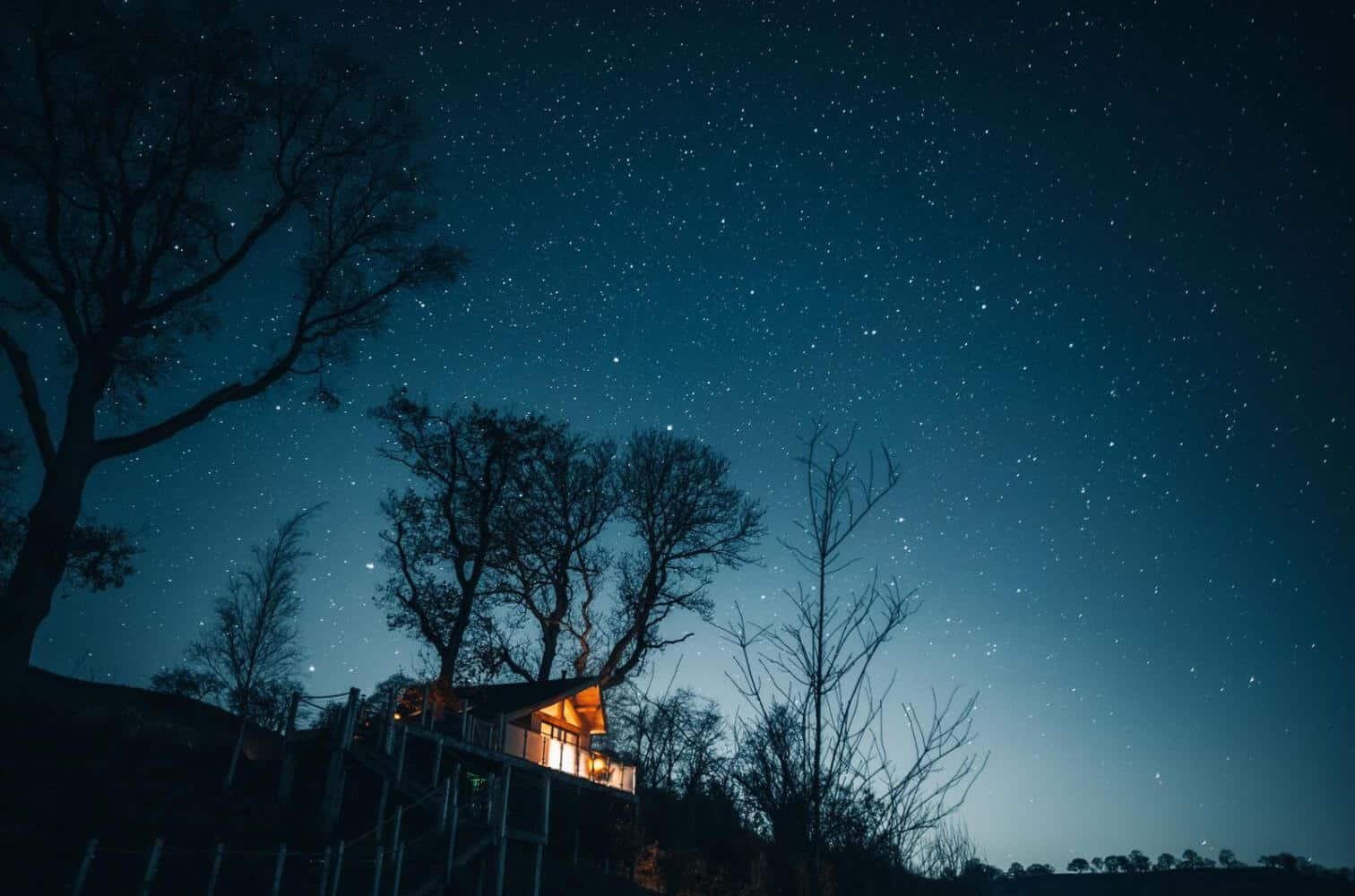 a large wooden house with clear starry skies above