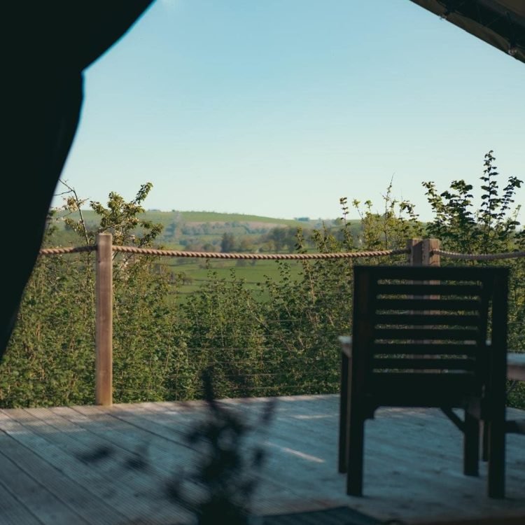 Beautiful countryside panorama viewed from inside the safari tent looking out onto the decking.