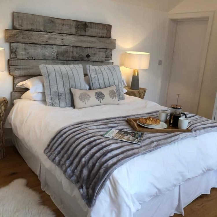 a bed with a tray of breakfast on it