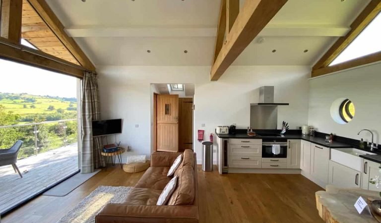 a wide view of a living room and kitchen in holiday accommodation
