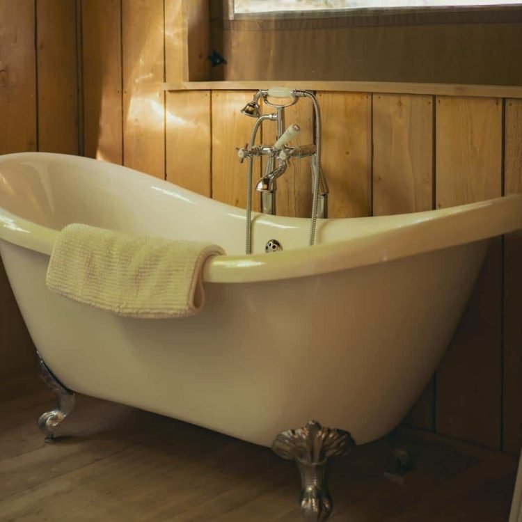 Close-up of the elegant freestanding bath inside the luxury safari tent bathroom at Oaklands Wales.